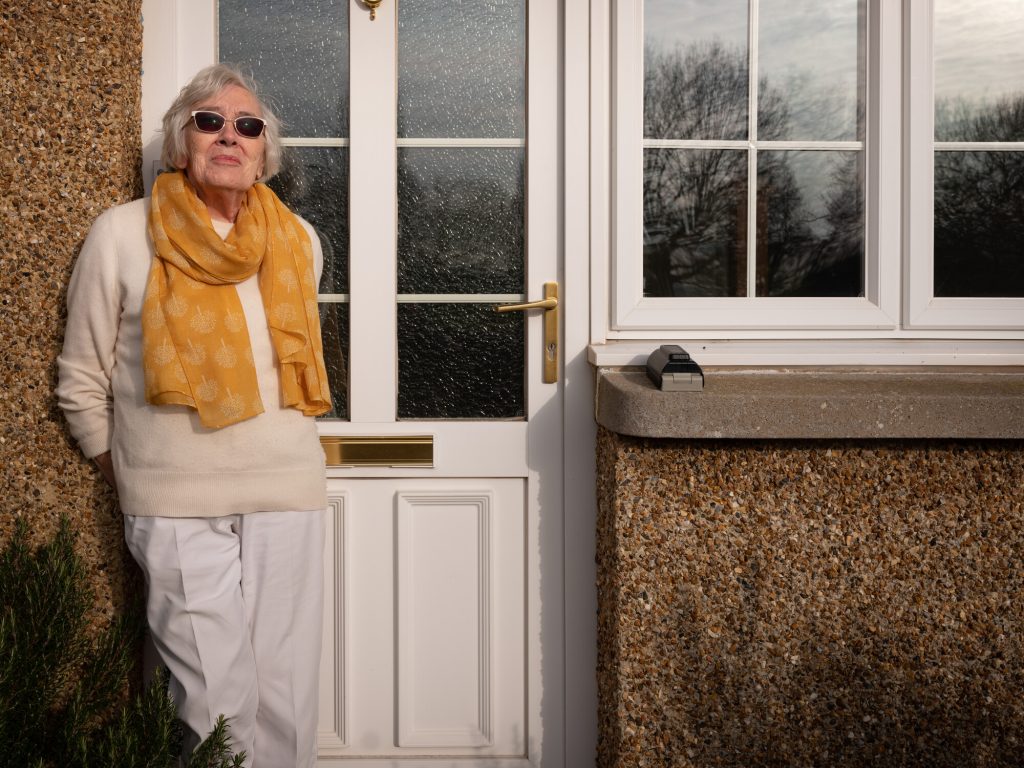 Woman Standing by Front Door of House